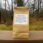 paper bag of tea with the woods on the back